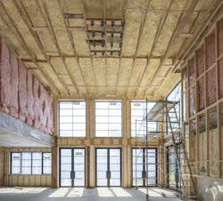 A combination of closed cell and open cell insulation achieves R-21 perimeter walls and an R-49 roof system. Batt insulation on the interior walls helps control sound transmission. Photo Credit: Michael Lipman Photography A combination of closed cell and open cell insulation achieves R-21 perimeter walls and an R-49 roof system. Batt insulation on the interior walls helps control sound transmission. Photo Credit: Michael Lipman Photography