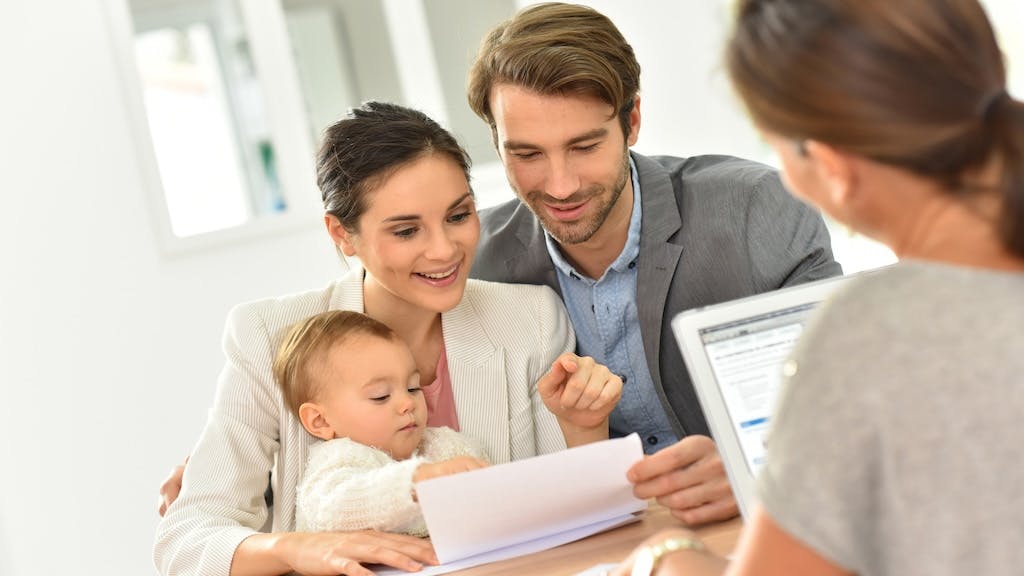 Couple going over paper work with a real estate agent