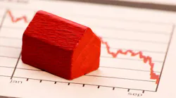 Model home sits on chart showing falling home prices