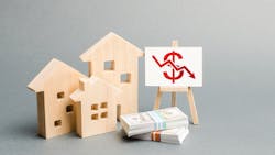 Model home sitting next to small pile of cash, indicating falling home equity Model home sitting next to small pile of cash, indicating falling home equity