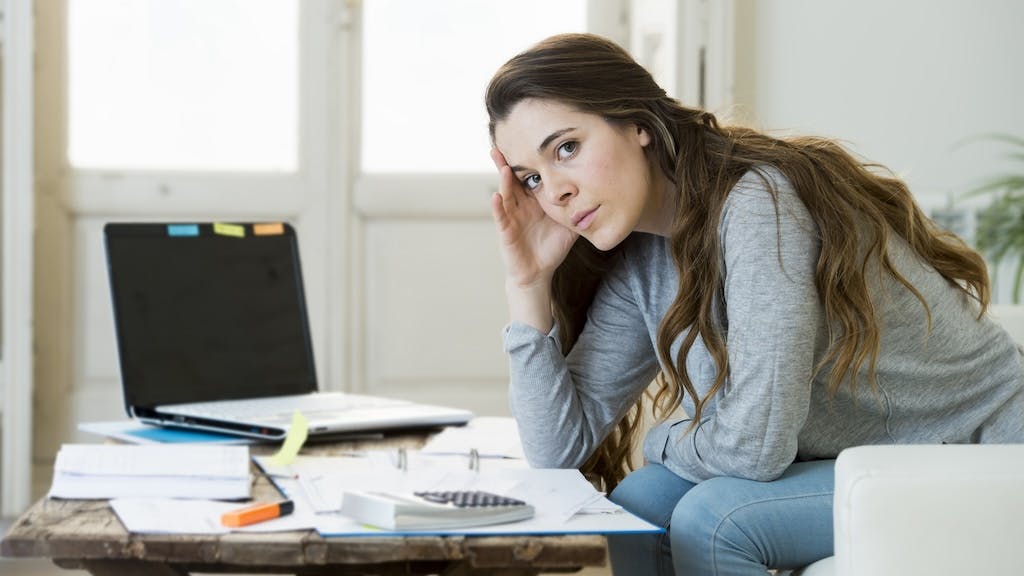 Prospective homebuyer looks over bills