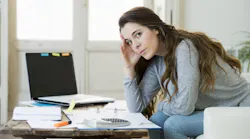 Prospective homebuyer looks over bills