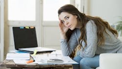 Prospective homebuyer looks over bills Prospective homebuyer looks over bills