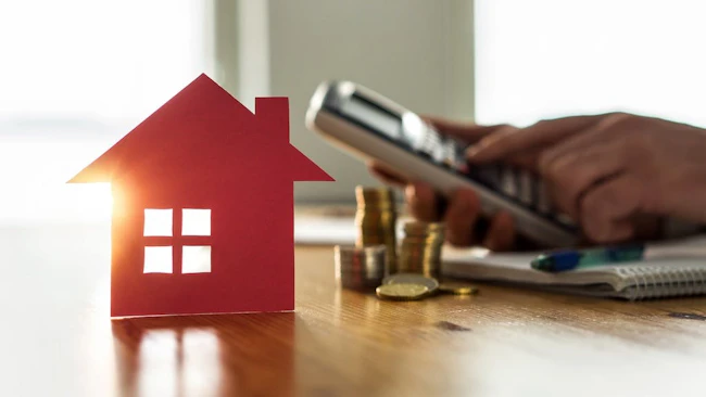 Homebuyer calculates housing costs on calculator