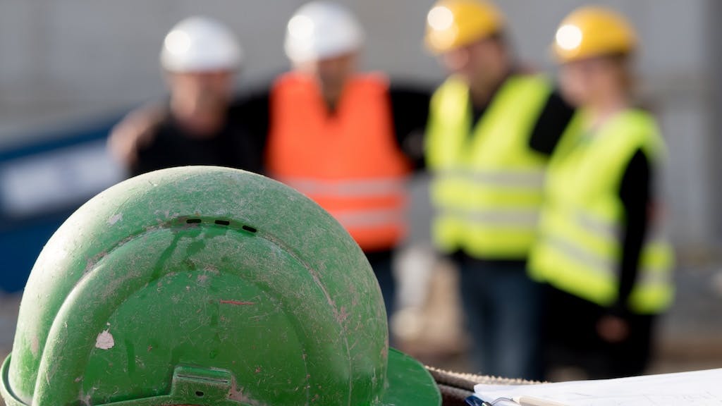 Construction workers huddling for a team meeting