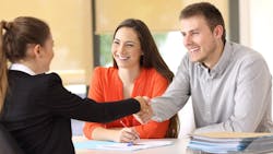 Homebuyers shaking hands with real estate agent Homebuyers shaking hands with real estate agent