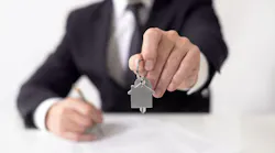 Investor holds up a house key