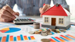 Homeowner calculating monthly expenses Homeowner calculating monthly expenses