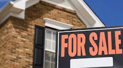 Brick home with a 'For Sale' sign in the front yard