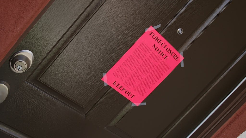 Foreclosure notice taped to the front door of a home
