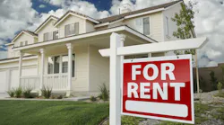 Home with a 'For Rent' sign in the front yard