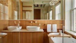 Bathroom showcasing flat-panel cabinets and wall-mounted faucets Bathroom showcasing flat-panel cabinets and wall-mounted faucets