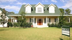 House with a 'For Sale' sign in the front yard House with a 'For Sale' sign in the front yard
