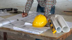 Home builder looking over plans at a jobsite