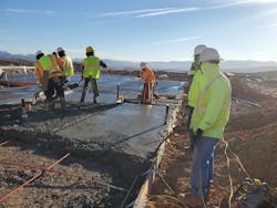 A concrete foundation and slab being properly consolidated by means of vibration, with an adequate number of workers on site to place and finish the pour. A concrete foundation and slab being properly consolidated by means of vibration, with an adequate number of workers on site to place and finish the pour.