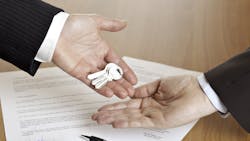 Real estate agent hands keys over to homebuyer Real estate agent hands keys over to homebuyer