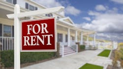 A 'For Rent' sign in front of a single-family home A 'For Rent' sign in front of a single-family home