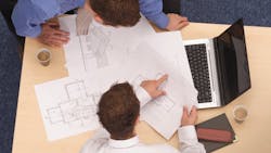 Project team going over house plans Project team going over house plans