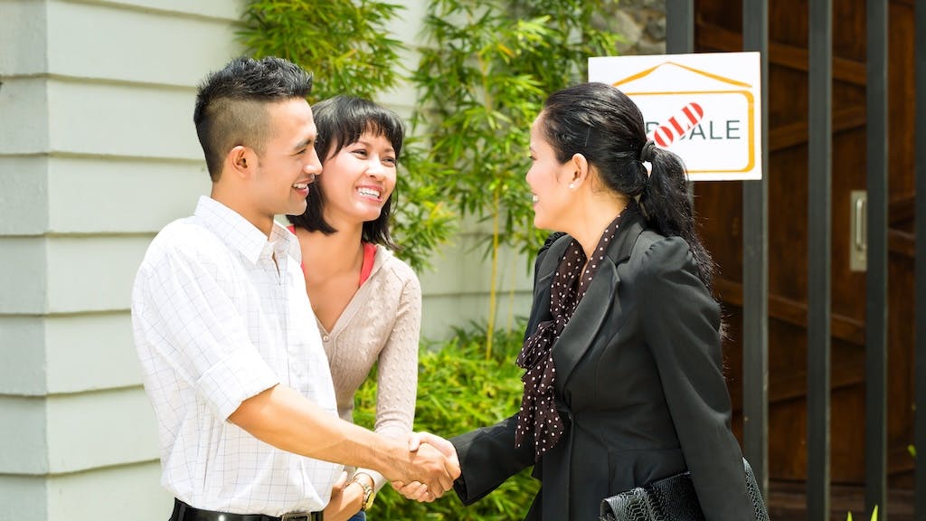 Gen Z couple touring a home with a real estate agent