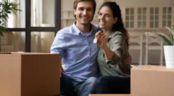 Millennial couple sitting near moving boxes in their new home