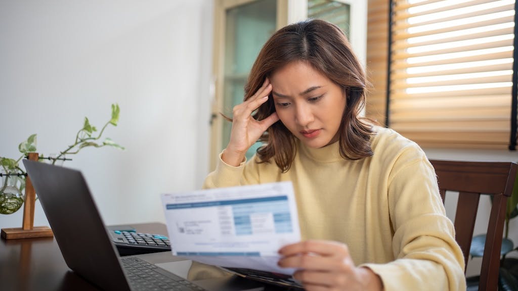 Single homeowner looking over bills
