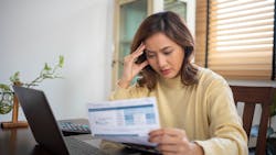 Single homeowner looking over bills Single homeowner looking over bills