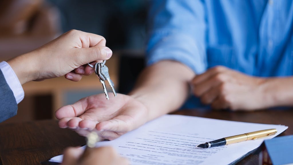 Homebuyer takes a pair of keys from real estate agent