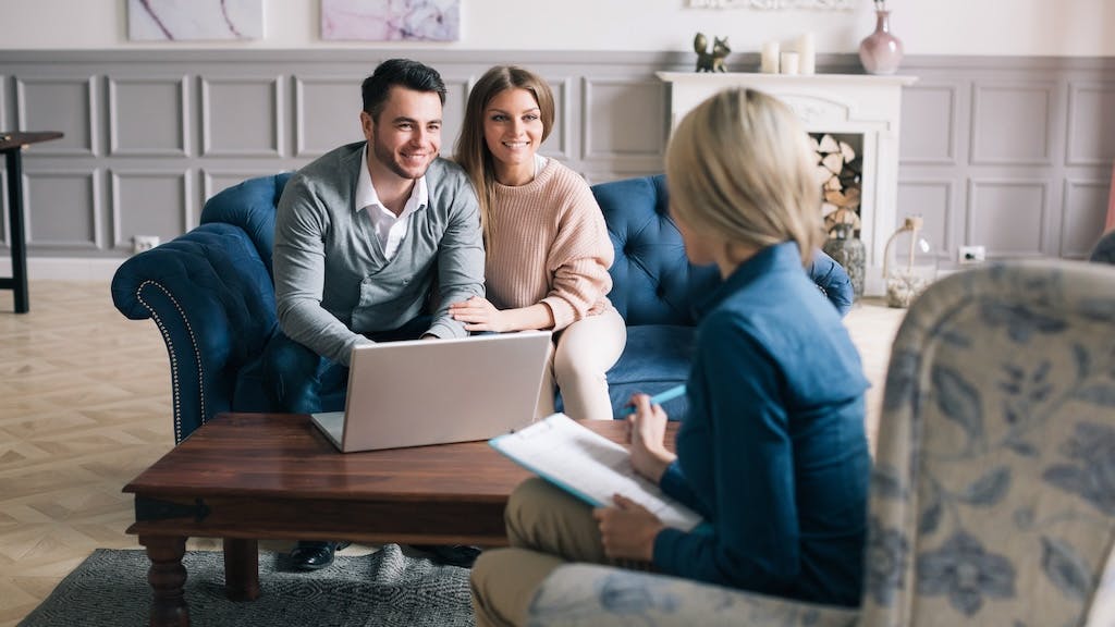 Young homebuyers meeting with a real estate agent