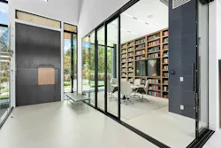 A generous glassed-in library adjacent to the entry foyer provides visual interest and connection to the common areas beyond, but still retains an air of intimacy and privacy. A generous glassed-in library adjacent to the entry foyer provides visual interest and connection to the common areas beyond, but still retains an air of intimacy and privacy.