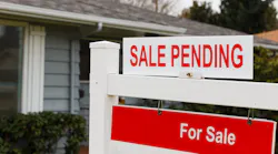 Sign posted in front yard showing a home sale is pending