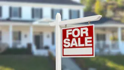 A 'For Sale' sign in front yard A 'For Sale' sign in front yard