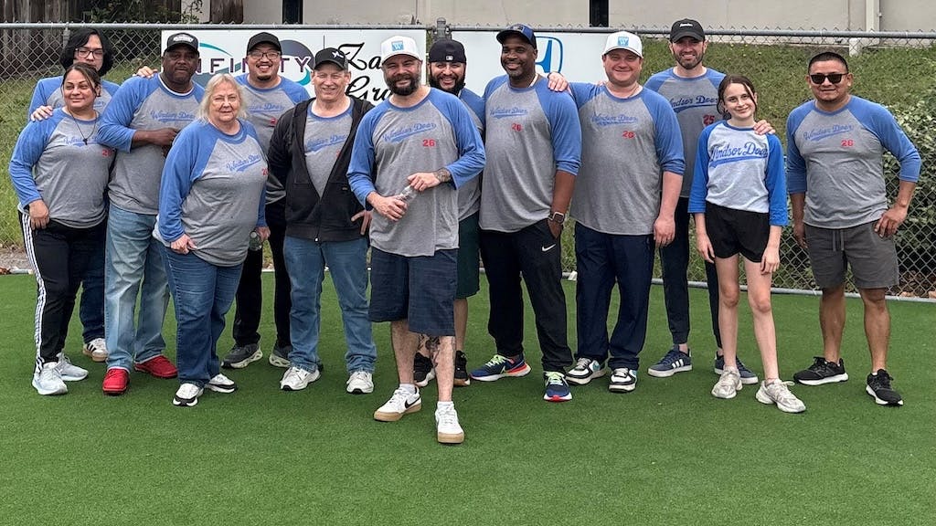 Company employees assisted the league during a baseball game, both on and off the field.