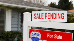 'Sale Pending' sign in a front yard
