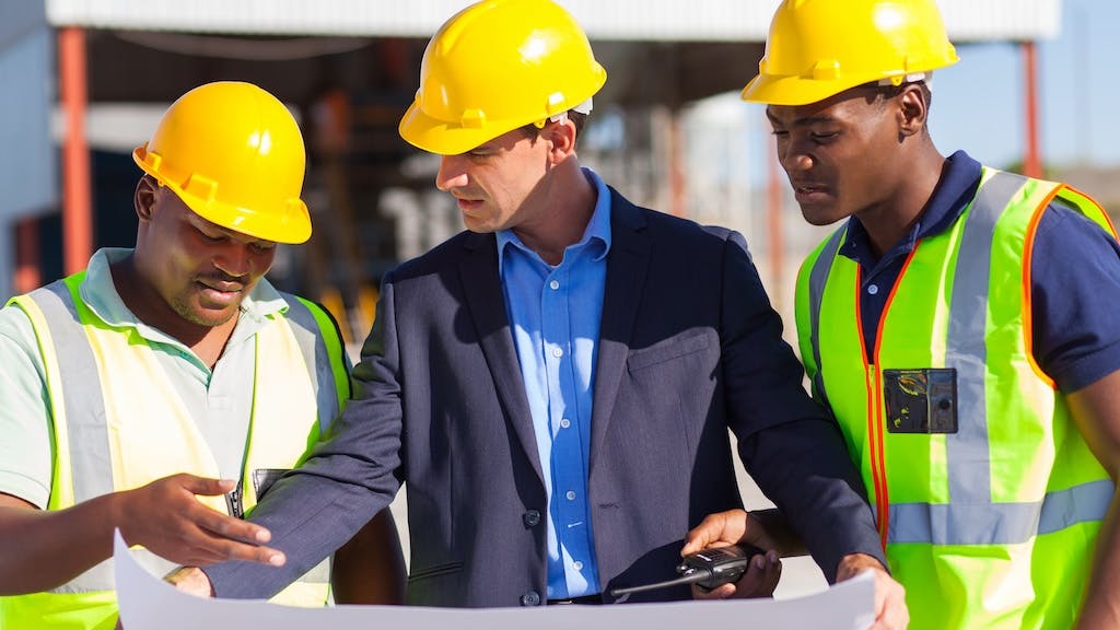 Construction workers looking over plans