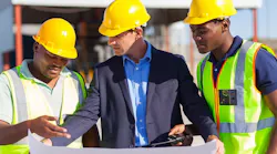 Construction workers looking over plans