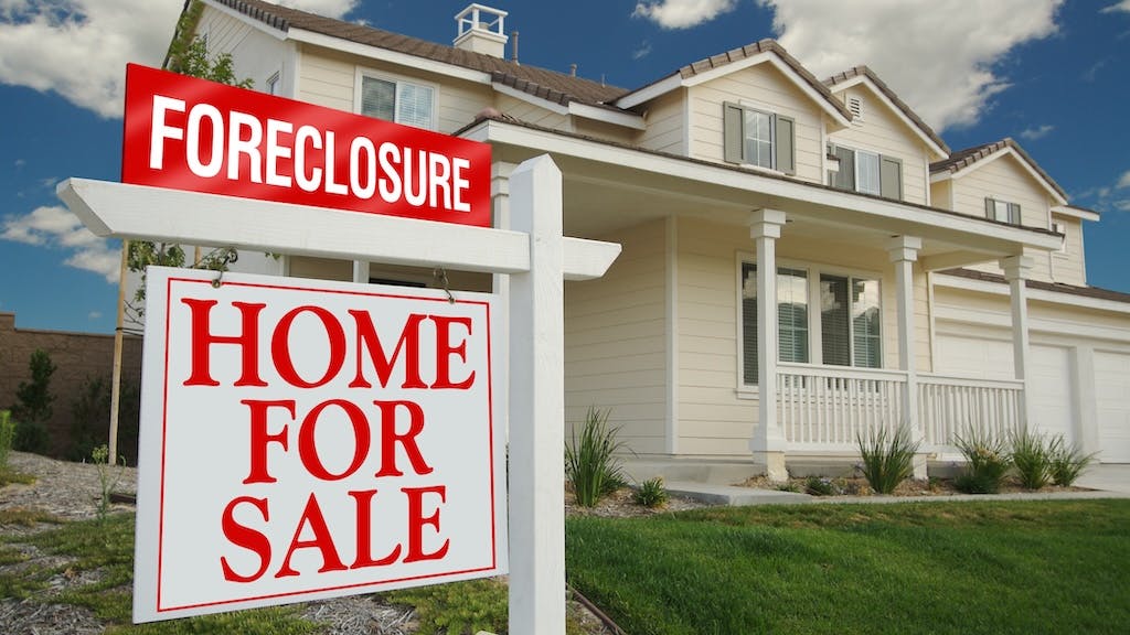 Foreclosure sign in front of a home