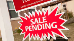 Pending sale sign posted in a front yard Pending sale sign posted in a front yard