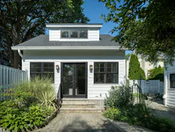 The exterior of the finished conversion of a 1922 storage garage maintained the original's style and size, but extended the width of the existing dormer window to allow more natural light into the space. The exterior of the finished conversion of a 1922 storage garage maintained the original's style and size, but extended the width of the existing dormer window to allow more natural light into the space.