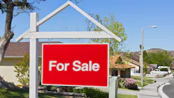For sale sign in the front yard of a suburban home For sale sign in the front yard of a suburban home
