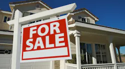 For Sale sign in a front yard