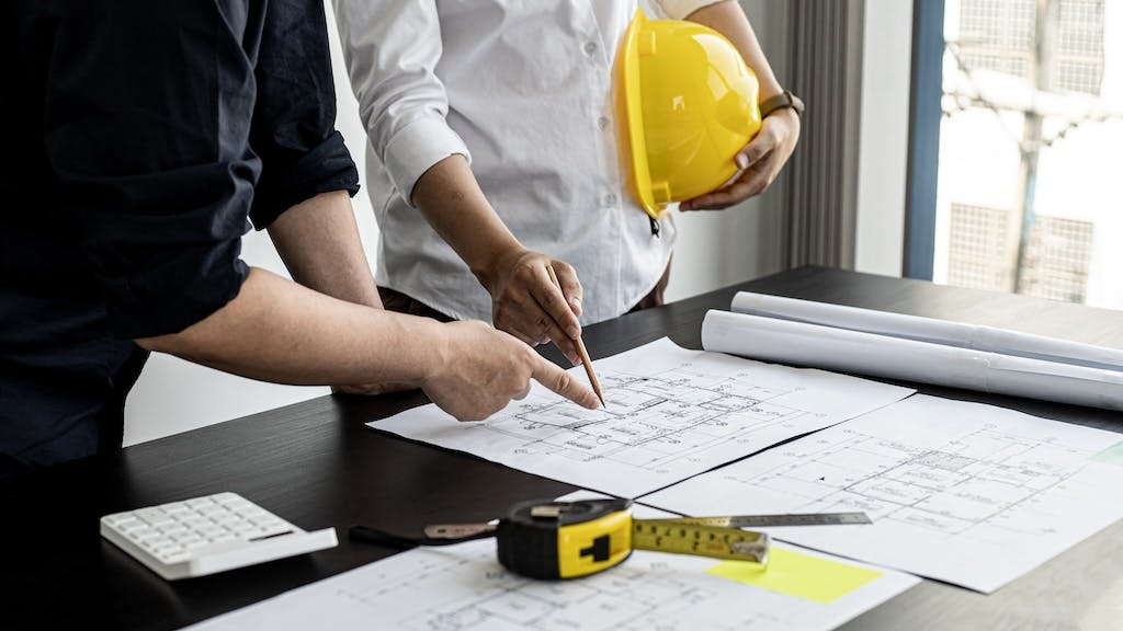 Builders going over house plans