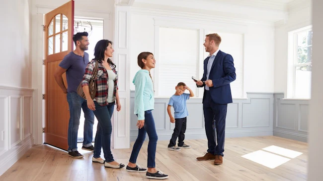 Homebuyers tour a house with a real estate agent