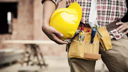Home builder holding a yellow hard hat