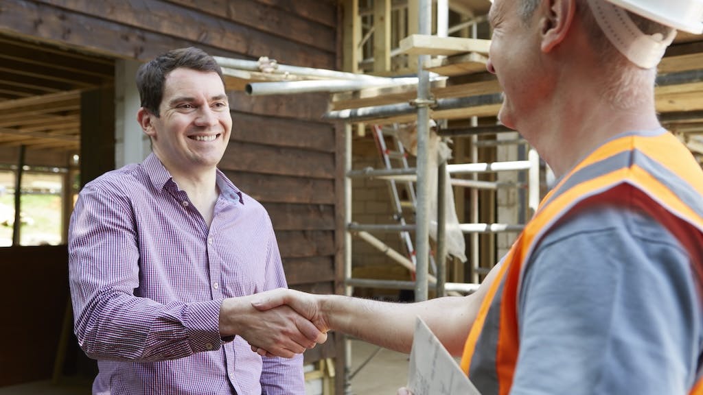 Builder shaking hands with a client