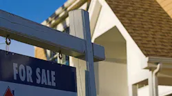 'For Sale' sign posted in a front yard