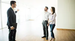 First-time buyers touring a home with a real estate agent
