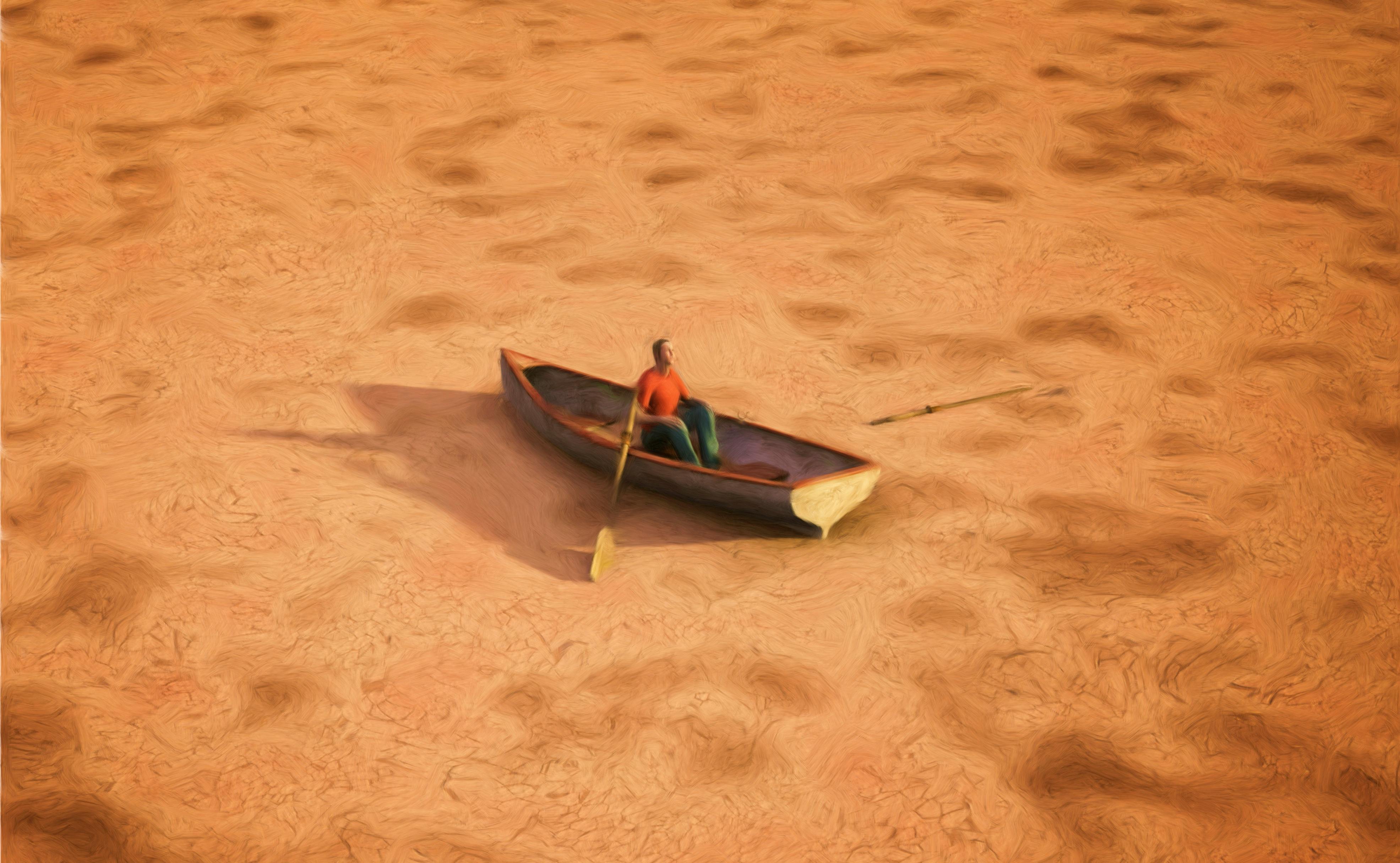 Man in a boat in a dry lakebed