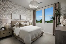 One of two private bedroom suites in Cadence’s Plan 2 townhomes by Melia Homes, designed by SummA Architecture for flexible living.
