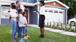 Family touring a luxury home with a real estate agent