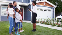Family touring a luxury home with a real estate agent